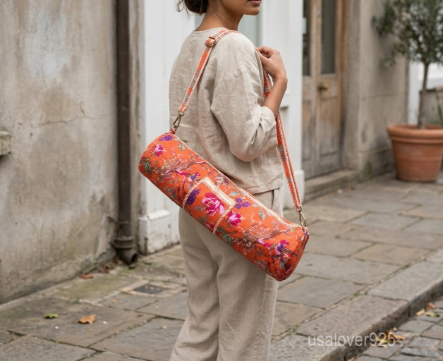 Orange Floral Cotton Yoga Mat Bag with an adjustable shoulder strap showing the vibrant botanical print.