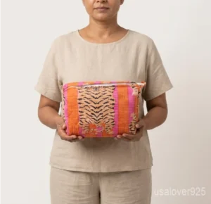 A three-piece nesting set of Orange Floral Quilted Cotton Toiletry Bags neatly arranged on a clean vanity counter showing the large, medium, and small size profiles.