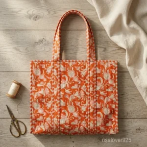 Orange Floral Quilted Cotton Tote Bag with comfortable shoulder handles showing the vibrant pink and white block print design.