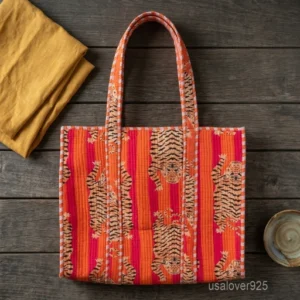 A person carrying a large Orange Quilted Cotton Tote Bag comfortably over their shoulder during a casual weekend travel trip.