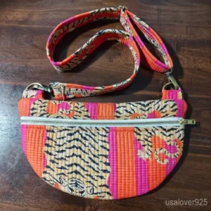 Woman at an outdoor festival carrying an Orange Tiger Print Quilted Mini Purse holding her phone and keys.