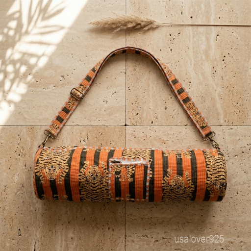 Woman walking to a workout studio carrying an Orange Tiger Quilted Cotton Yoga Mat Bag comfortably as a crossbody sling.