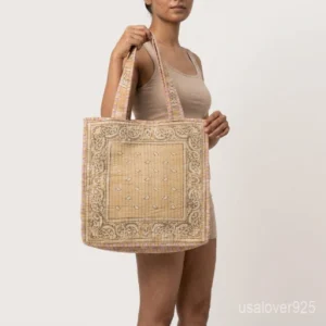 Close-up of the dense Kantha running stitching patterns, soft fabric texture, and reinforced double handles on a red cotton shopper bag.