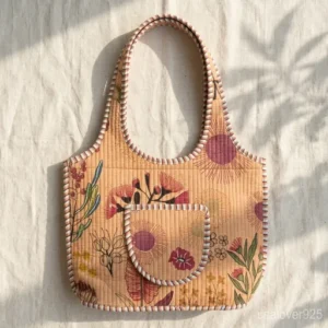 Close-up of delicate peach botanical hand-block print patterns and high-quality quilted stitching on a Floral Quilted Cotton Tote Bag.