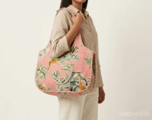 Close-up of intricate hand-block printing patterns and high-quality top zipper on a Jungle Print Quilted Boho Tote.