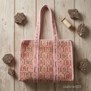A person carrying a Pink Floral Block Print Quilted Cotton Tote Bag comfortably over their shoulder during a casual city commute.