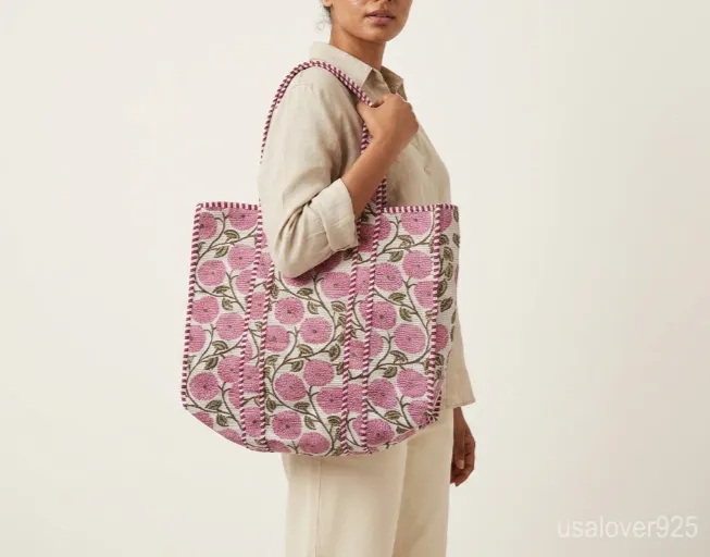 Pink Floral Hand Block Print Quilted Cotton Tote Bag with comfortable matching fabric straps held against a neutral background.