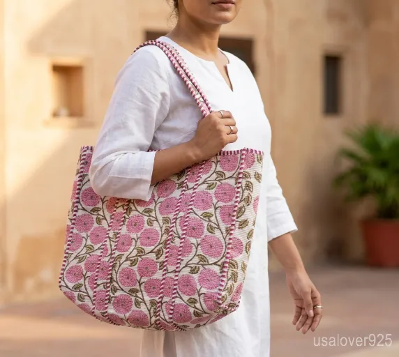 Pink Floral Hand Block Print Quilted Cotton Tote Bag with comfortable matching fabric straps held against a neutral background.