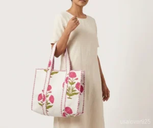 Close-up of delicate pink botanical print patterns and high-quality quilted stitching on an extra large cotton tote bag.