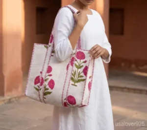 Pink Floral Quilted Cotton Tote Bag with comfortable over-the-shoulder handles held against a natural background.
