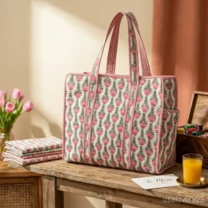 Close-up of intricate pink botanical hand-block print patterns and high-quality Kantha-style quilted stitching on a cotton tote bag.