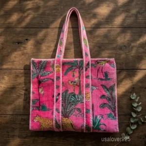 A person carrying a large Pink Floral Velvet Quilted Tote Bag comfortably over their shoulder during a casual weekend travel trip.
