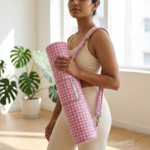 Close-up of the handcrafted pink checkered detailing, dense quilted stitching tracks, heavy-duty metal clasps, and adjustable crossbody strap on an Indian cotton fitness mat bag.