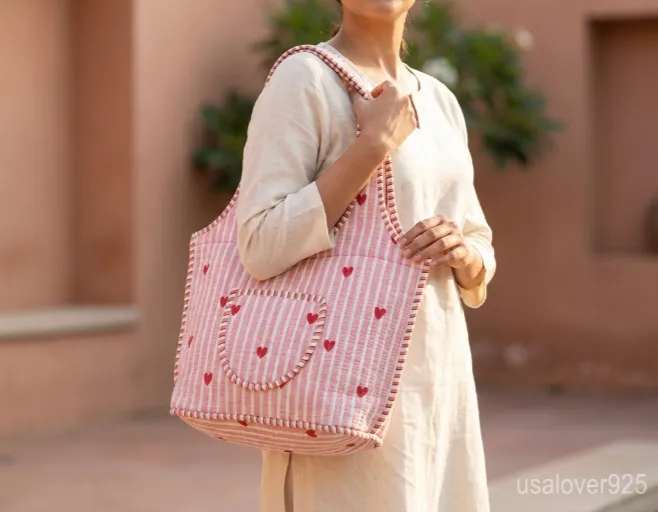 Pink Red Quilted Cotton Tote Bag with comfortable over-the-shoulder handles held against a natural background.