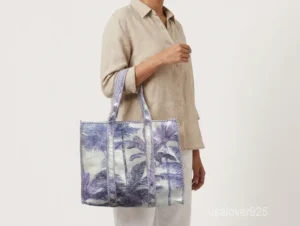 Close-up of the purple palm tree motif detailing, dense parallel line quilted stitching rows, and reversible double-sided pattern layout on an Indian cotton tote bag.