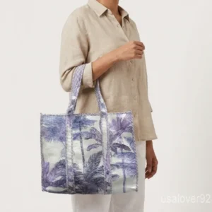 Close-up of the purple palm tree motif detailing, dense parallel line quilted stitching rows, and reversible double-sided pattern layout on an Indian cotton tote bag.