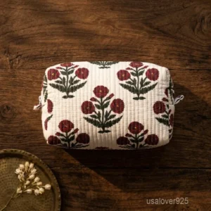 A large profile Quilted Cotton Makeup Pouch neatly arranged next to skincare accessories on a clean bathroom vanity counter showing its spacious layout capacity.