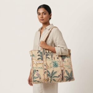 A shopper carrying the Jungle Print Quilted Cotton Tote Bag by the wide straps, showcasing its generous packing capacity and vibrant bohemian accessory style at an outdoor market.