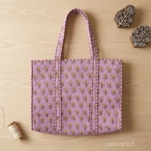 A person carrying a large Quilted Cotton Tote Bag comfortably over their shoulder during a weekend getaway beach trip.