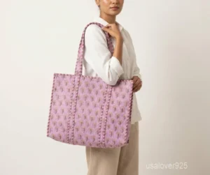 Close-up of the handcrafted pattern print detailing, dense parallel line quilted stitching rows, and comfortable 13-inch shoulder handles on an Indian cotton tote bag.