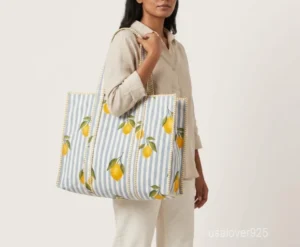 Close-up of the handcrafted pattern print detailing, dense parallel line quilted stitching rows, and comfortable 13-inch shoulder handles on an Indian cotton tote bag.
