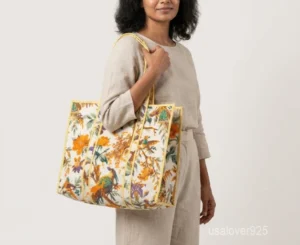 Close-up of the handcrafted pattern print detailing, dense parallel line quilted stitching rows, and comfortable 13-inch shoulder handles on an Indian cotton tote bag.