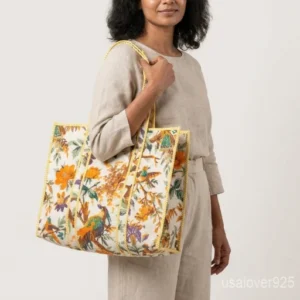 Close-up of the handcrafted pattern print detailing, dense parallel line quilted stitching rows, and comfortable 13-inch shoulder handles on an Indian cotton tote bag.