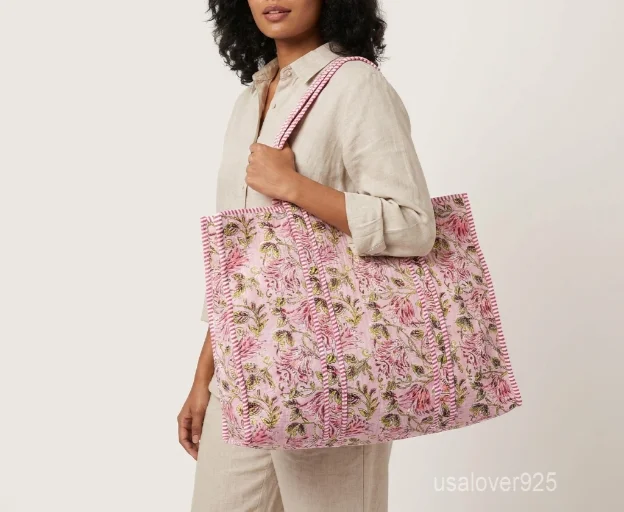 Close-up of the handcrafted pattern print detailing, dense parallel line quilted stitching rows, and comfortable 13-inch shoulder handles on an Indian cotton tote bag.