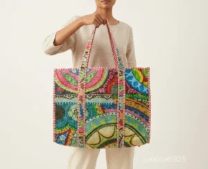 Close-up of the traditional block print detailing, dense parallel line quilted stitching rows, and comfortable 13-inch shoulder handles on an Indian cotton tote bag.