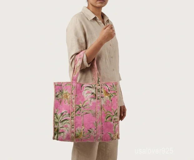 Close-up of the plush velvet ethnic print, dense parallel line quilted stitching rows, deep 6.5-inch gusset base, and comfortable reinforced shoulder handles on an Indian shopper bag.