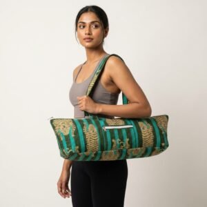 Close-up of the handcrafted green tiger print detailing, dense quilted stitching texture lines, robust handle strap attachments, and exterior front zipper pocket on an Indian cotton Pilates carrier bag.
