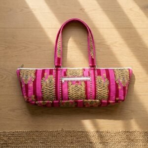 Close-up of the handcrafted pink tiger print detailing, dense quilted stitching texture lines, robust handle strap attachments, and exterior front zipper pocket on an Indian cotton Pilates carrier bag.