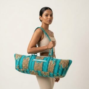 A fitness enthusiast carrying the Quilted Tiger Cotton Yoga Mat Bag over the shoulder by the wide straps, showcasing its long profile and classic bohemian accessory style while heading to a gym class.