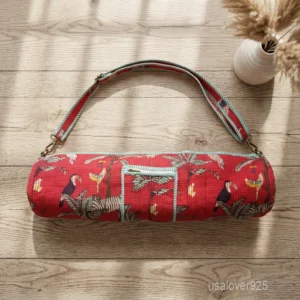 Woman walking to a workout studio carrying a Red Quilted Cotton Yoga Mat Bag comfortably as a crossbody sling.