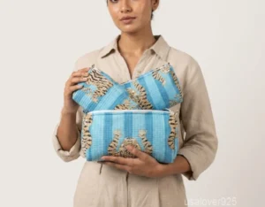 Close-up of the handcrafted botanical print detailing, dense vertical quilted stitching rows, waterproof internal plastic lining, and built-in inside pockets on an Indian cotton cosmetic caddy pouch.