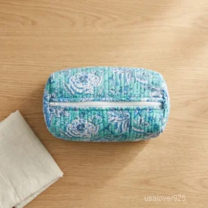 A three-piece nesting set of Quilted Makeup Bags Cotton Toiletry Set neatly arranged on a clean vanity counter showing the large, medium, and small size configurations.