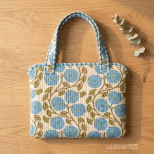 Sky Blue Floral Laptop Sleeve showing the traditional hand block print artisan design with the smooth zipper closure and double carry handles.