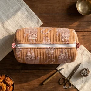 A three-piece nesting set of Tiger Print Quilted Toiletry Bag Set neatly arranged on a clean vanity counter showing the large, medium, and small size configurations.