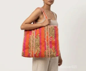 A person carrying a Tiger Print Quilted Cotton Tote Bag comfortably over their shoulder during a casual city commute.