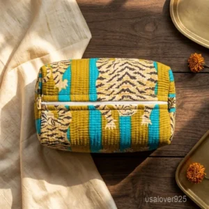 A three-piece nesting set of Tiger Print Quilted Toiletry Bag Set neatly arranged on a clean vanity counter showing the large, medium, and small size configurations.