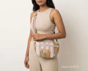 A person holding a compact Tiger Print Soft Quilted Cotton Mini Bag by its top handle during an evening party outing.