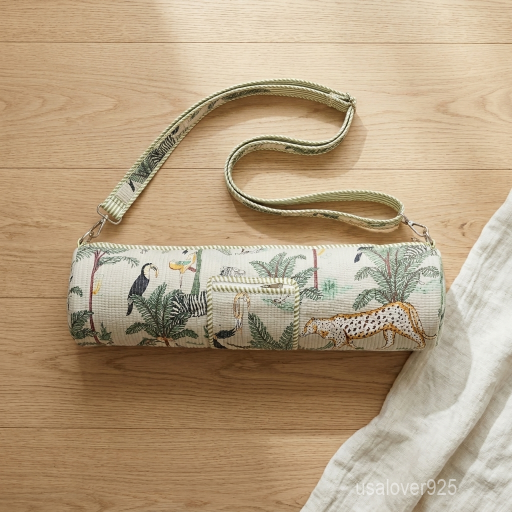 Close-up of the convenient integrated exterior pocket, top closure system, and premium quilted stitching on a wild cat print cotton yoga bag.