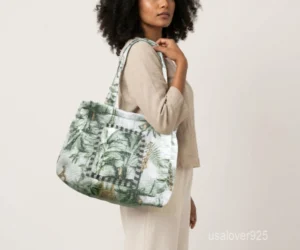 Close-up of the dense parallel line quilted stitching patterns, soft fabric texture, and reinforced double handles on a green cotton shopper bag.