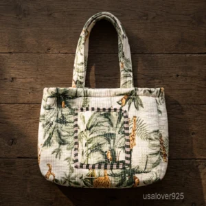 Tropical Leaf Quilted Cotton Tote Bag with double handle shoulder straps showing the green botanical foliage print layout.