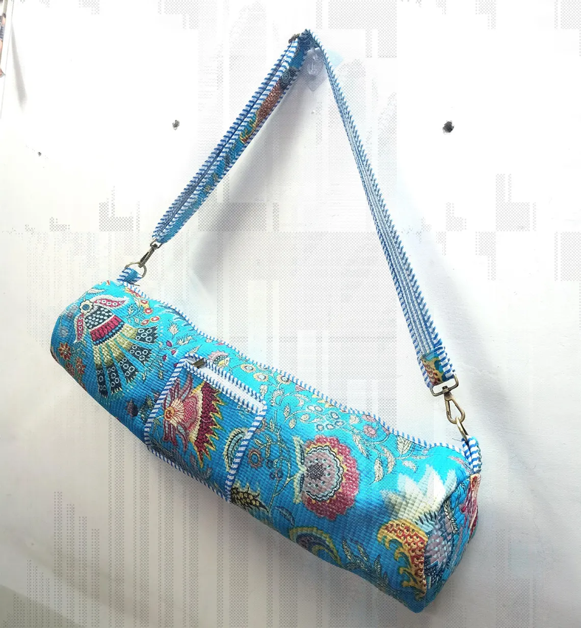 Blue Floral Quilted Cotton Yoga Mat Bag with an adjustable shoulder strap showing the vibrant bohemian botanical print.