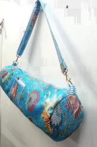 Close-up of the smooth-glide secure zipper closure, premium wide adjustable strap, and crisp floral pattern details on a blue cotton yoga bag.