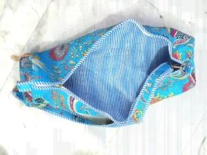 Woman walking to an outdoor workout session carrying a Blue Floral Quilted Cotton Yoga Mat Bag comfortably as a crossbody sling.