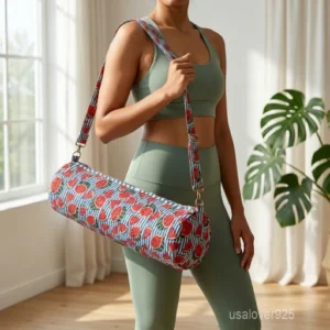 A fitness enthusiast carrying the Watermelon Fruit Quilted Yoga Mat Bag over the shoulder by the wide strap, showcasing its slim profile and vibrant bohemian accessory style while heading to an outdoor practice session.