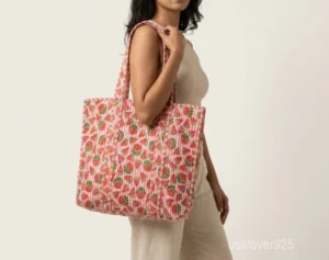 Close-up of the traditional hand-running Kantha embroidery stitches, playful watermelon motif detailing, soft cotton fabric texture, and handles on an Indian upcycled shopper bag.