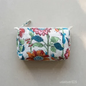 A three-piece nesting set of White Block Print Quilted Cotton Toiletry Bags neatly arranged on a clean vanity counter showing the large, medium, and small size profiles.
